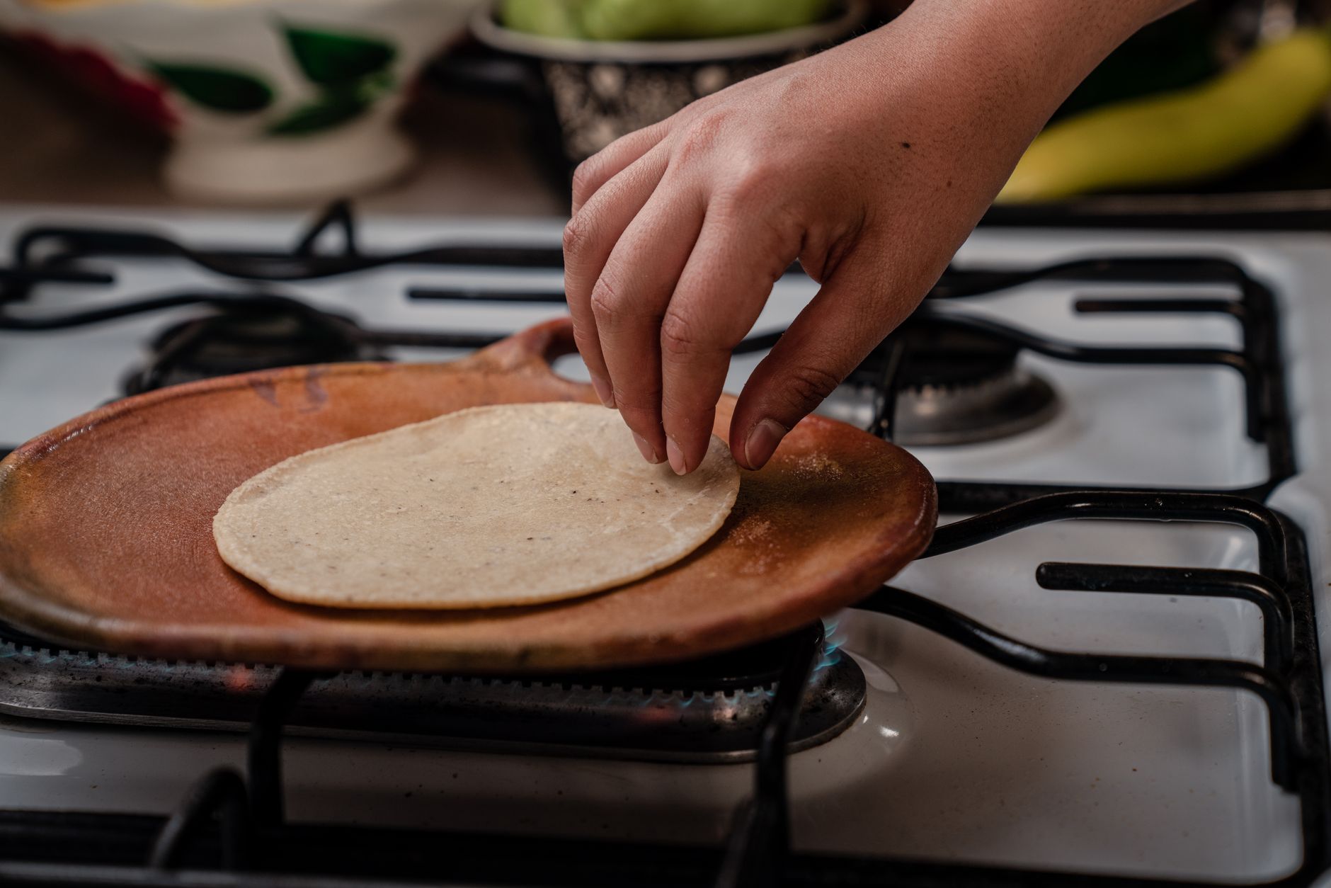 Clay comal stove with freshly pressed tortillas and dried chilies in Oaxaca